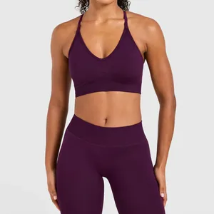Front detail of a dark purple seamless yoga bra with high-waist matching sports leggings