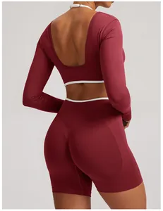 Back view detail of seamless burgundy yoga set with long sleeves and open back design