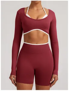 Detailed front view of maroon seamless yoga set with contrast white piping accents