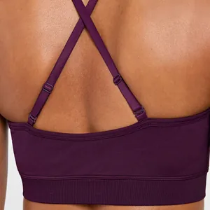 Close-up of seamless purple yoga bra featuring adjustable criss-cross back straps