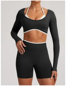 Close-up of seamless black long-sleeve yoga top and shorts with white contrast trim