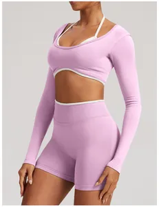 Side view of pink seamless long-sleeve yoga top and shorts set for women's fitness.