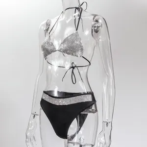 Sexy two-piece bikini set with shimmering silver rhinestones on a clear mannequin