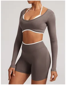 Detail of seamless long sleeve yoga set with white halter bra and taupe shorts