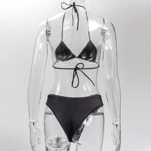 Sexy black rhinestone bikini set with halter neck tie on transparent mannequin.