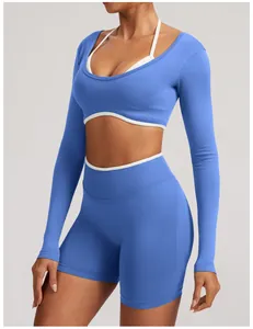 Detailed view of a blue seamless long-sleeve yoga set featuring stylish white trim accents