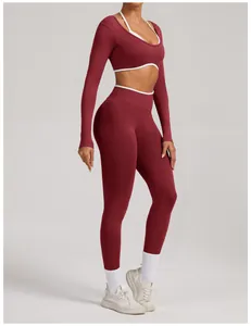 Full body view of burgundy seamless long-sleeve yoga set with white trim on model