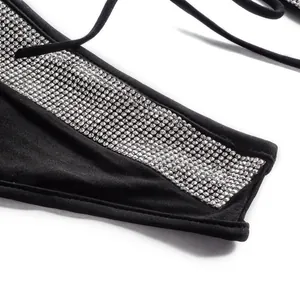 Close-up detail of low-waist black bikini bottom with decorative silver rhinestones.