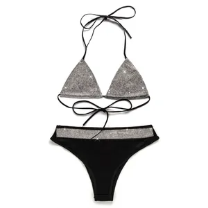 Detail of sexy black two-piece bikini set with sparkling silver rhinestone accents.
