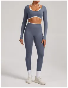 Full-body view of a seamless dusty blue yoga set with white contrast trim and long sleeves.