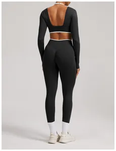Back view of a seamless black yoga set with long sleeves and open-back detail