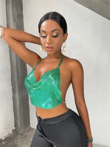 Close-up detail of a vibrant green metal sequin halter top on a stylish fashion model