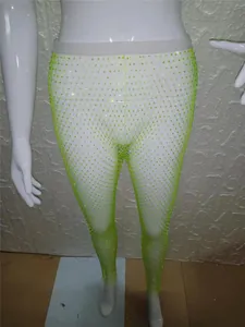 Detalle de los leggings de rejilla verde neón con pedrería en un maniquí blanco