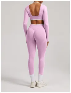 Back view of pink seamless long-sleeve yoga set with open back and high-waist leggings.
