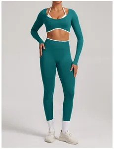 Teal seamless yoga set with long sleeve crop top and high waisted leggings for fitness