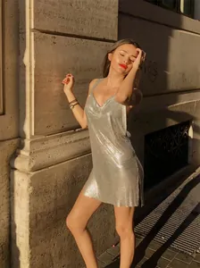 Close-up of a glamorous silver metallic sequin mini dress for nightclub fashion style