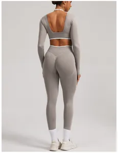 Gray seamless yoga set for women featuring long sleeve backless crop top and leggings