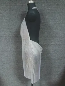 Detailed side view of a sexy silver metallic sequin halter dress displayed on a black mannequin.