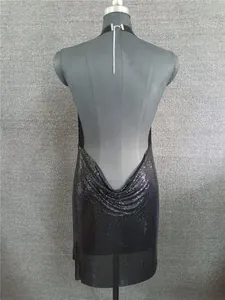 Detailed back view showing the cowl drape of a black sequin backless halter dress