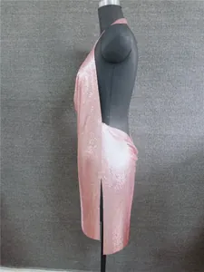 Detailed side profile of a shimmering pink metallic sequin backless mini dress on mannequin