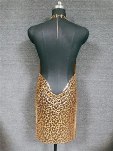 Back view detail of a gold leopard print metallic sequin halter dress on mannequin