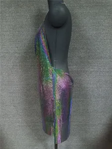 Side profile of a colorful iridescent metal sequin halter dress on a mannequin.