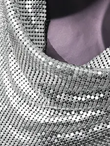 High-definition close-up showing the shimmering silver metallic sequin mesh of a halter neck top