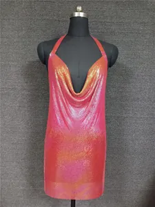 Detail shot of a pink and orange gradient metallic sequin halter mini dress on mannequin