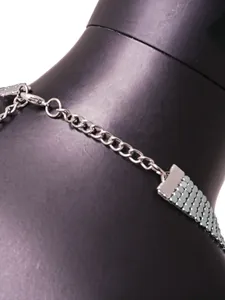 Close-up detail of silver metallic sequin halter vest with an adjustable chain clasp.
