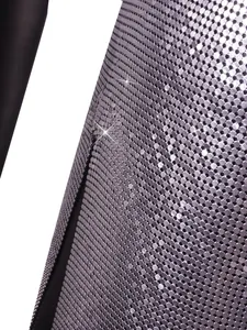 Close-up detail of silver metallic chainmail fabric for sexy nightclub party dress.
