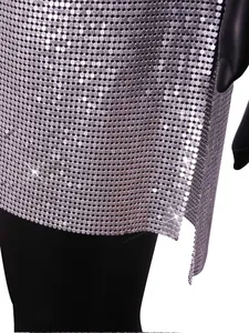 Close-up detail of silver metallic chainmail sequin fabric on a clubwear dress