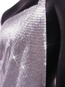 Detailed view of shimmering silver metal sequin mesh fabric on a sexy nightclub party dress