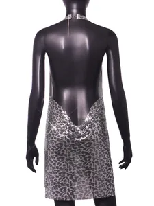Back view of a silver leopard print metal sequin mini dress with a deep backless cowl design.