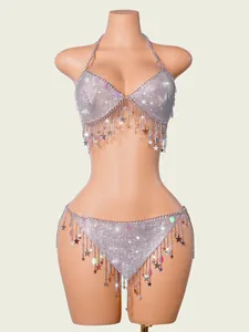 Close-up of sparkling silver mesh body chain set with star tassels