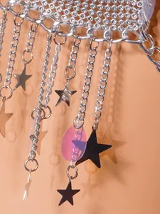 Detail view of a silver body chain featuring mesh rhinestones and hanging star-shaped tassels