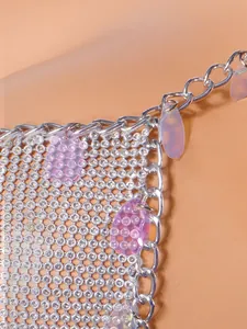 Detailed macro shot of a silver rhinestone mesh body chain with iridescent purple sequins