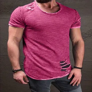 Detailed view of the distressed holes on a men's burgundy short sleeve T-shirt