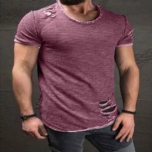 Close-up view of men's distressed short sleeve T-shirt featuring ripped hole details.