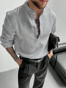 Close-up detail of men's gray striped seersucker shirt with stand collar and button front