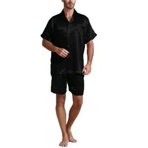 Full length view of black satin pajama shirt and matching shorts on standing model