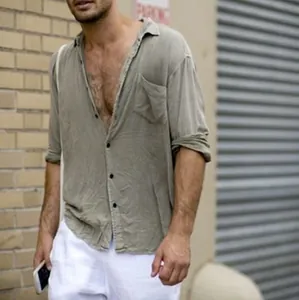 Close-up of a men's olive linen shirt featuring a lapel collar and chest pocket