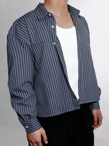 Detail view of a men's navy blue pinstriped loose casual shirt with long sleeves