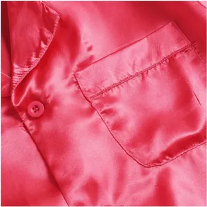 Detailed close-up showing the smooth satin texture, pocket and button of pink men pajamas