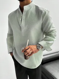 Detail view of men's green striped long-sleeve shirt with seersucker texture