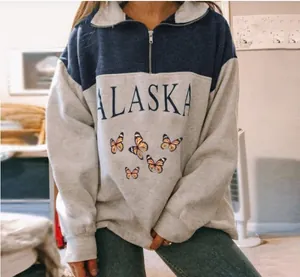 Detailed view of women's grey and blue half-zip sweatshirt with Alaska and butterfly print