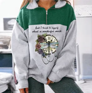 Detailed view of women's color-blocked sweatshirt with vintage dragonfly floral print and zipper