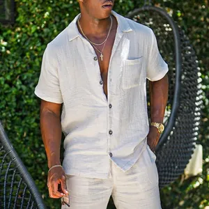Detailed view of a men's loose fit beige cotton linen short sleeve shirt outdoors