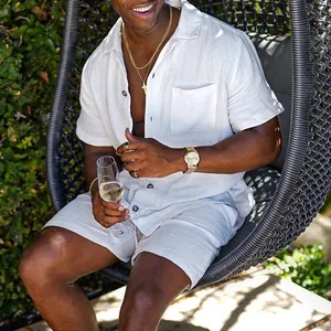 Male model wearing white cotton linen shirt and shorts set in outdoor garden