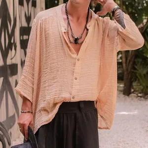 Detail shot of men's apricot cotton linen shirt showing breathable fabric texture and relaxed fit.