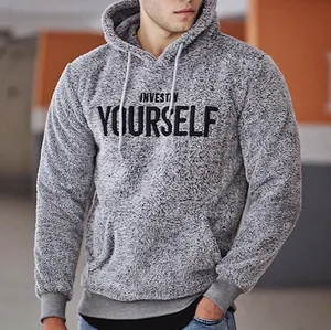 Detailansicht eines grauen Fleece-Hoodies mit 'Invest In Yourself' Bruststickerei.